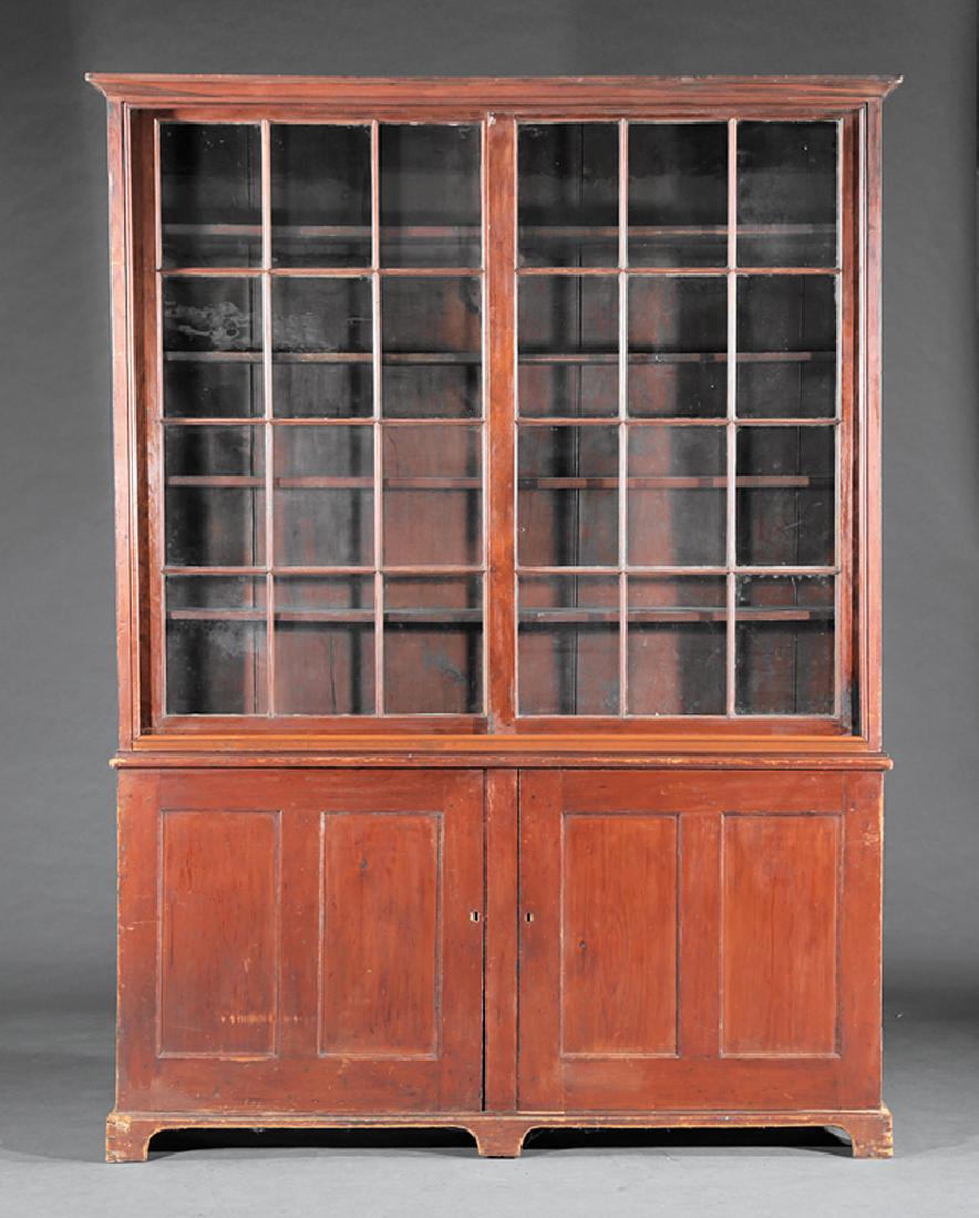 American Carved Pine Bookcase: Large American Carved Pine Bookcase, 19th c., likely Southern, molded cornice, two sliding glazed doors, shelf interior, lower cabinet with two paneled doors, one side with divided interior, bracket f