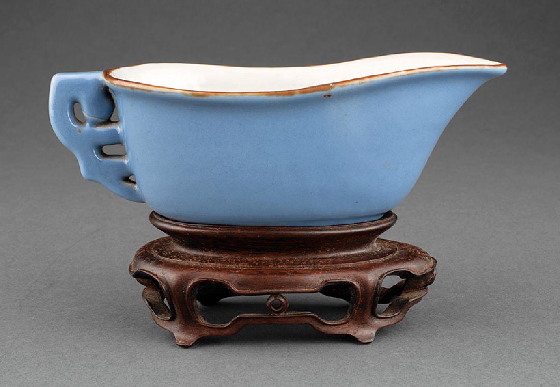 Chinese Blue Glazed Porcelain Libation Vessel: Chinese Blue Glazed Porcelain Libation Vessel, Yongzheng mark and probably period (1723-1735), stylized dragon handle, brown glazed rim, elongated tapering body, base marked, h. 2 1/8 in., w. 6 3/8 in