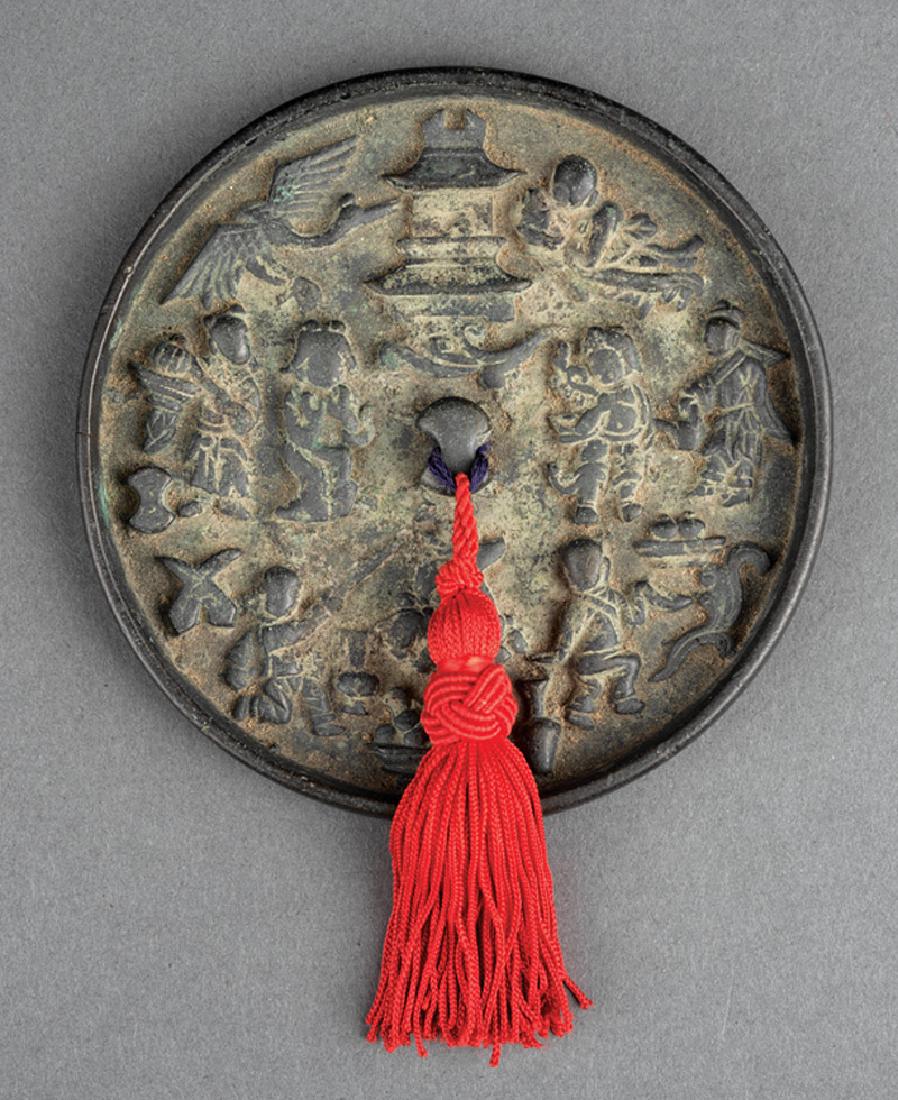 Chinese Bronze Mirror: Chinese Bronze Mirror, relief cast with numerous figures, a pagoda, a crane, and a deer, dia. 4 1/8 in. Provenance: The Sturm Collection