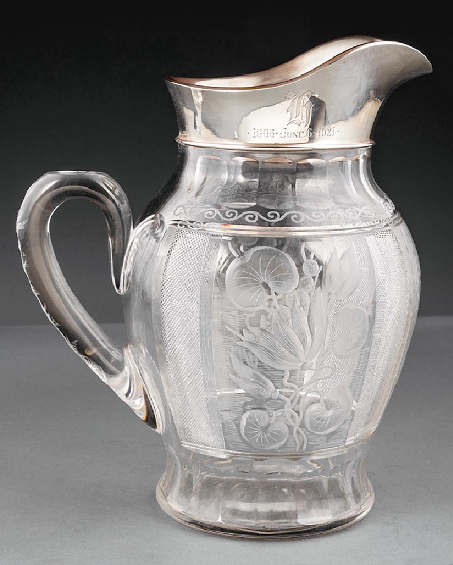 Gorham Sterling Silver-Mounted Cut Glass Pitcher: Gorham Sterling Silver-Mounted Cut Glass Water Pitcher, no. 3293D, date mark for 1920, intaglio cut glass with lotus blossoms and leaves, h. 10 7/8 in. Provenance: The Sturm Collection