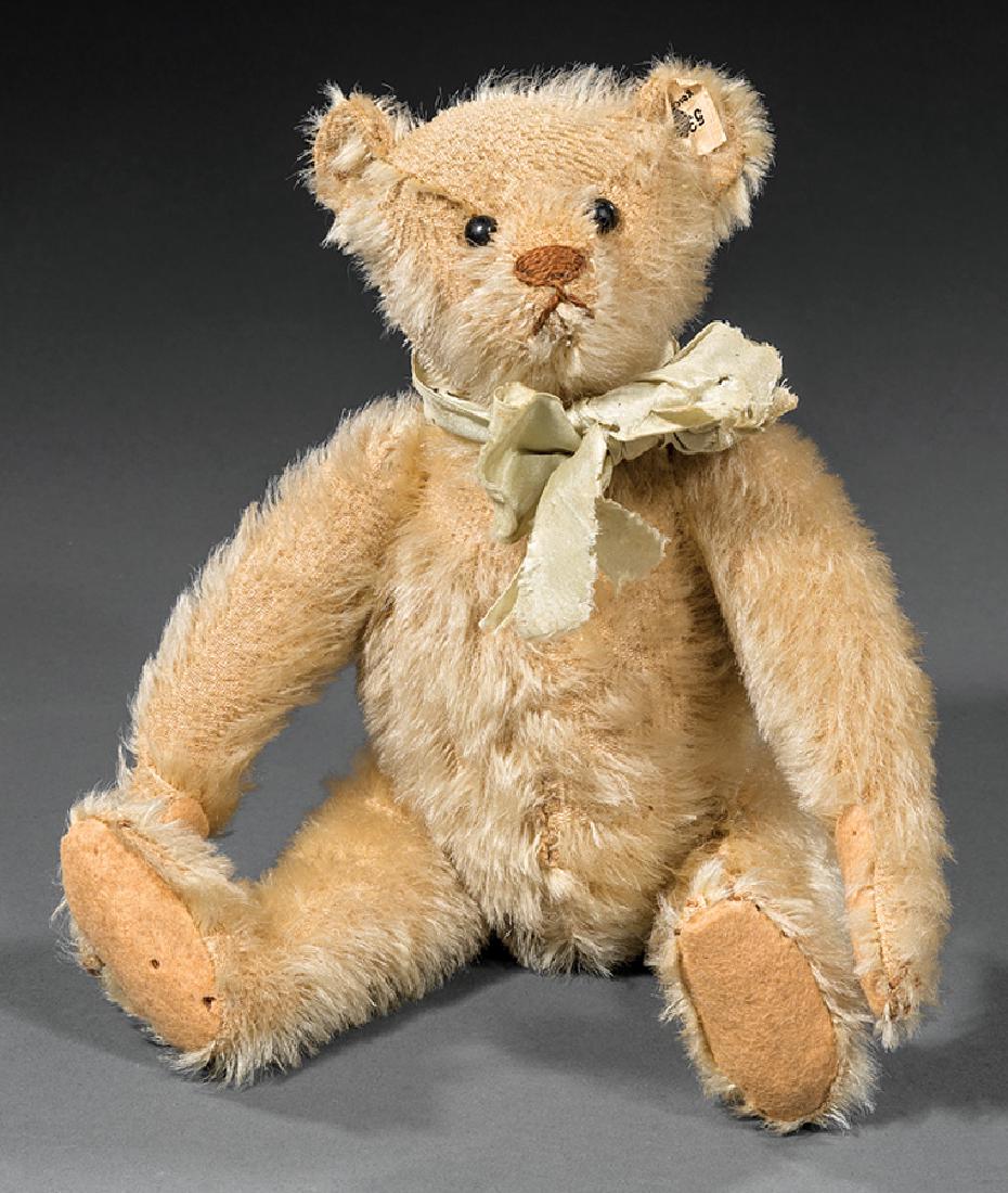 Steiff Teddy Bear: Steiff Teddy Bear, c. 1905, gold mohair, marked with blank button and tag remnant, original pads and nose, black shoe button eyes, fully jointed, h. 10 in