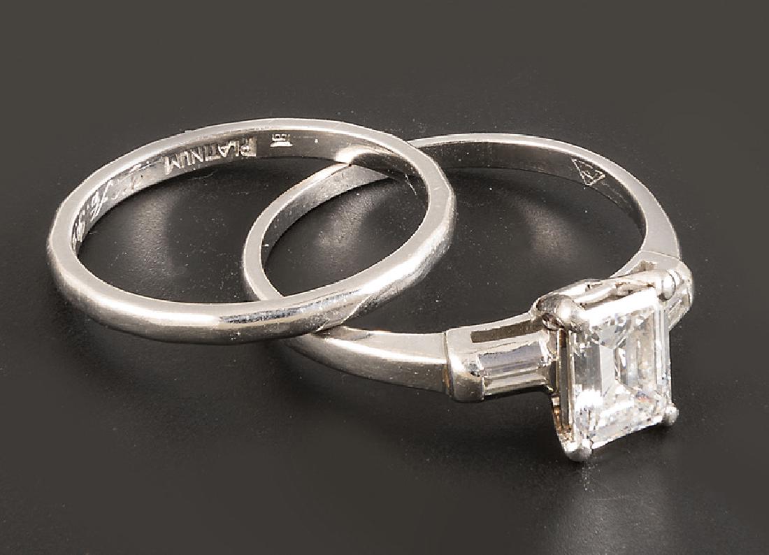 Platinum and Diamond Solitaire Ring: Platinum and Diamond Solitaire Ring, set with 1 emerald cut diamond, approx..95 ct., color H-I, clarity VS1-VS2, and 2 baguette diamonds totaling approx..15 ct.; with platinum wedding band, w. 1.5 mm.