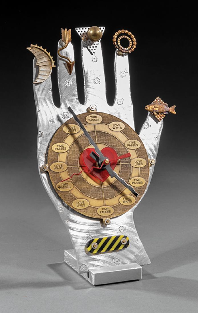 Thomas Mann (American/New Orleans, 20th c.): Thomas Mann (American/New Orleans, 20th c.), "Techno Hand Clock", steel and mixed media, artist stamp on reverse of hand, h. 9 1/2 in., w. 6 1/4 in., d. 3 1/4 in