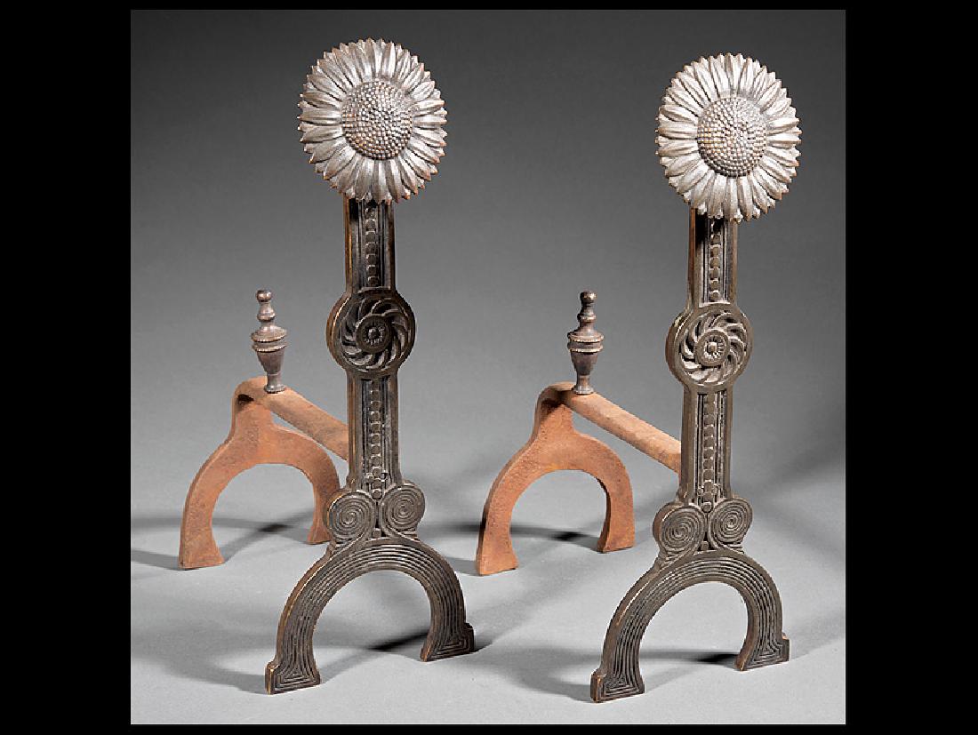 English Bronze and Cast Iron Fire Dogs: English Bronze and Cast Iron Fire Dogs, in the style of Thomas Jeckyll (1827-1881), London, low relief with sunflower terminals supported by a flat column with stylized floral roundels above a U-shape