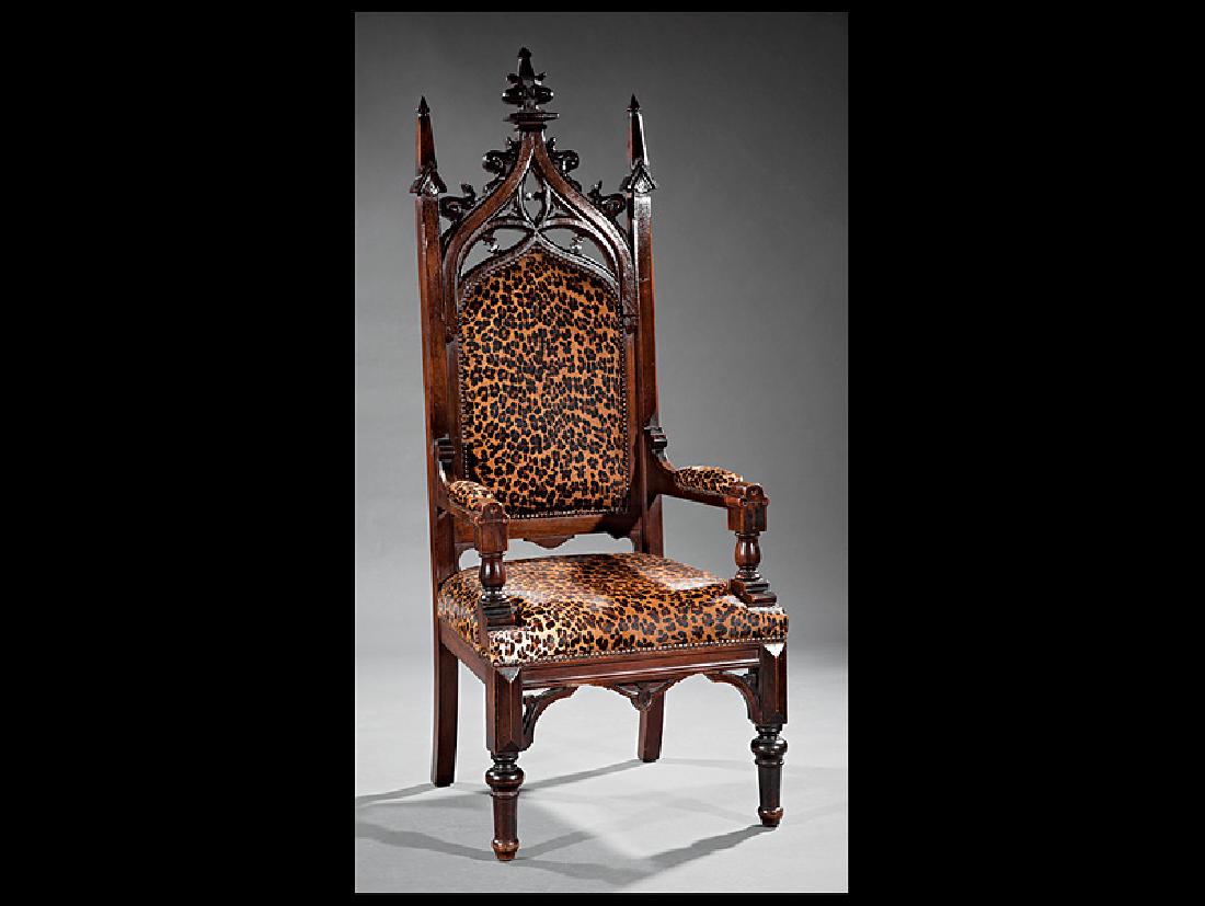 American Gothic Carved Walnut Library Armchair: American Gothic Carved Walnut Library Armchair, mid-19th c., high back surmounted by crocket finial, reticulated crest, cowhide leopard print padded back, seat, and arms, blocked seat rail, turned leg