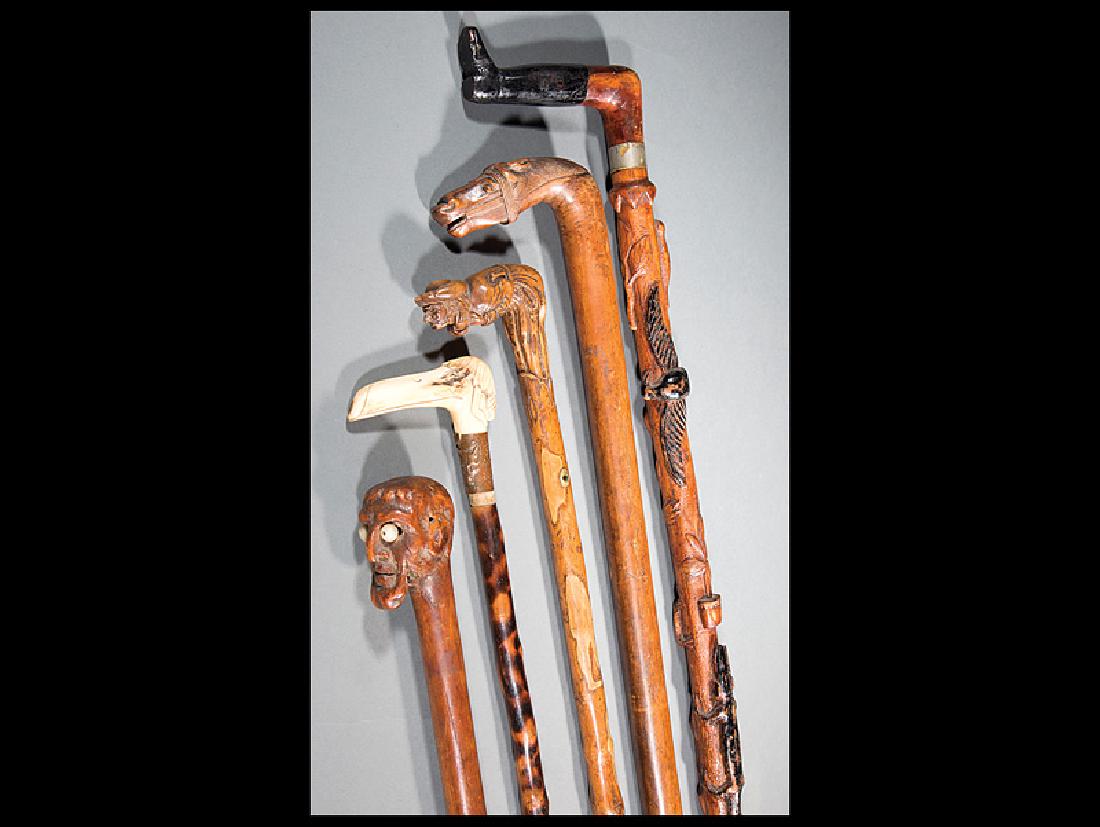 Five Folk-Art Walking Sticks: Five Antique Folk-Art Walking Sticks, incl. a friar, carved bone bird; booted leg, shaft carved with animals and objects; horse head, shaft carved with place-name "KEPKYPA"; and head with "googly" eye