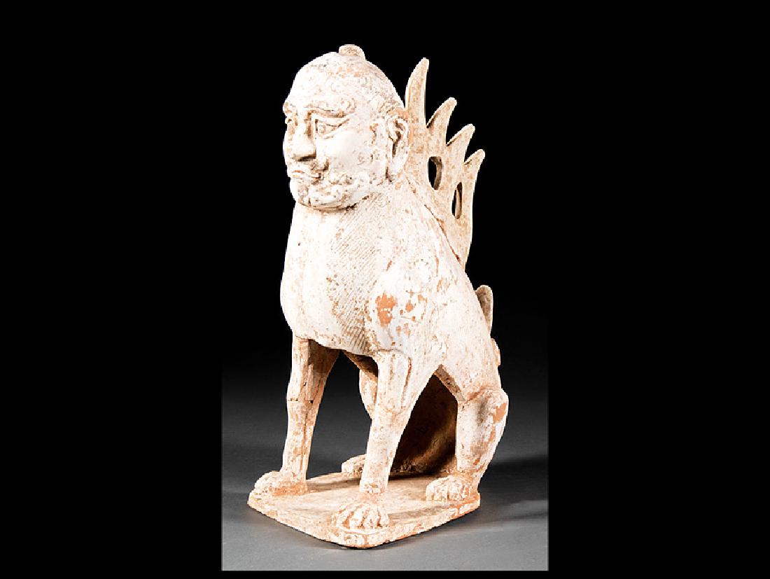 Chinese Pottery Earth Spirit: Chinese Pottery Earth Spirit, possibly Tang Dynasty (618-907), modeled with feline body and human face seated on its haunches, h. 14 in