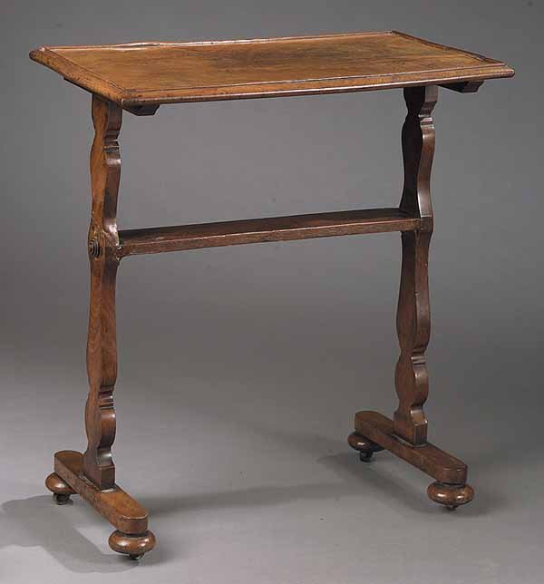 A Small American Figured Mahogany Tray: A Small American Figured Mahogany Tray Top Side Table , 19th c., the molded top above scalloped trestle supports with medial stretcher and shoe feet ending in flattened balls, height 26 in., width 13