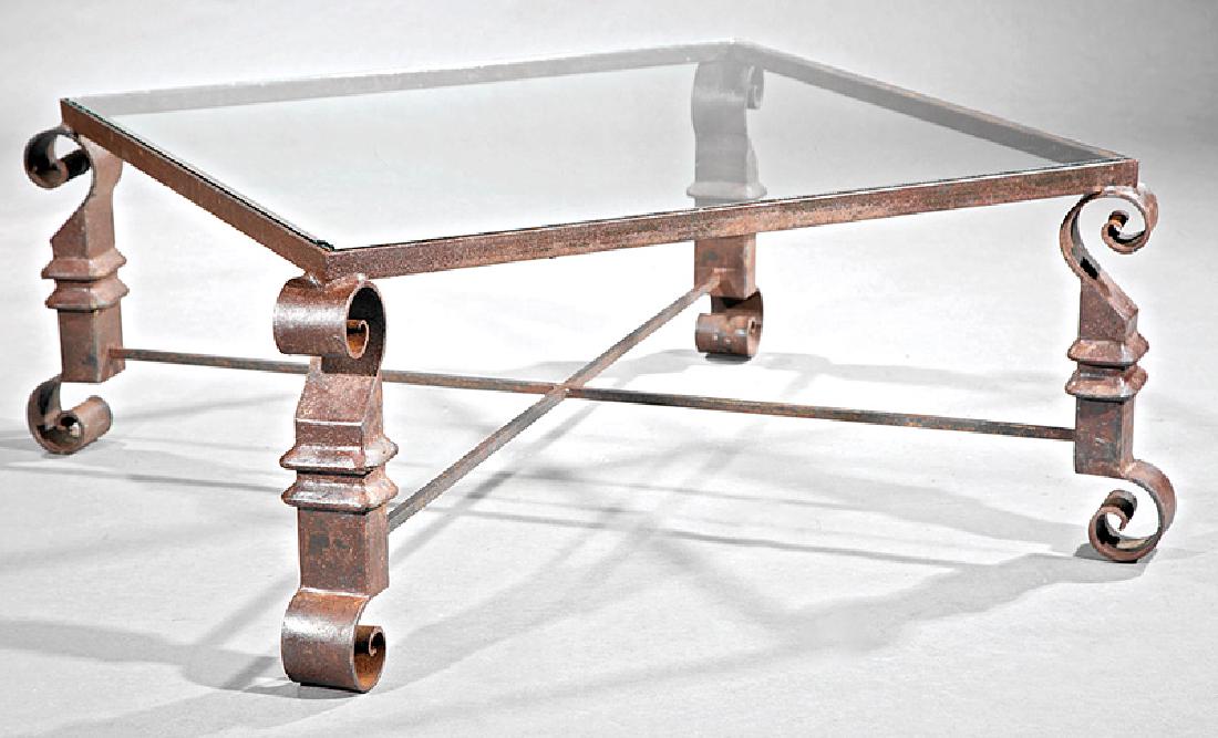 Continental Cast Iron and Glass Low Table: Continental Cast Iron and Glass Low Table, early 20th c., in the style of Gilbert Poillerat, inset glass top, X stretcher, connected to scrolled and blocked canted legs, h. 17 3/8 in., w. 40 in., d. 4