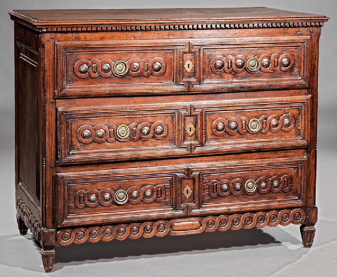Louis XVI Carved and Brass-Mounted Oak Commode: Louis XVI Carved and Brass-Mounted Oak Commode, 18th c., dentil-molded top, guilloche-carved long drawers and skirt, paneled returns, blocked and tapered feet, h. 40 in., w. 49 3/4 in., d. 24 1/2 in