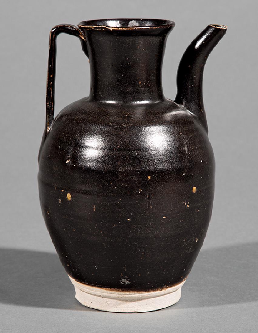Chinese Black Glazed Pottery Ewer: Chinese Black Glazed Pottery Ewer, probably Song Dynasty (960-1279), black glaze with a tight network of crackle that thins to brown around the edges and stops above the light gray biscuit foot, h. 7 