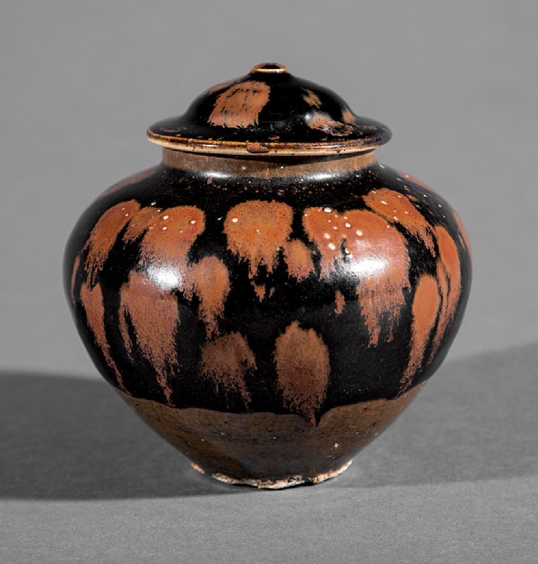 Chinese Black and Brown Glazed Stoneware Jar: Chinese Russet Splashed Black and Brown Glazed Stoneware Jar, probably Song Dynasty (960-1279), upper body with russet streaks on a black ground that pools over the brown glazed lower section, h. 4 1/