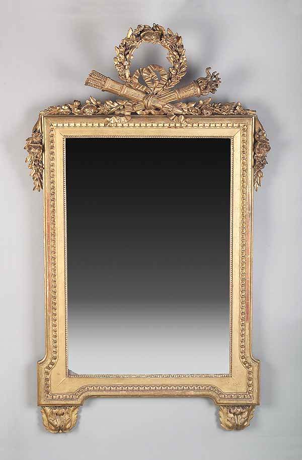 Antique Louis XVI-Style Carved Giltwood Mirror: An Antique Louis XVI-Style Carved Giltwood Mirror , mid-19th c., the crest with quiver arrows and torch bound by a beribboned garland, swagged garlands to the sides, beaded and facited frame ending in