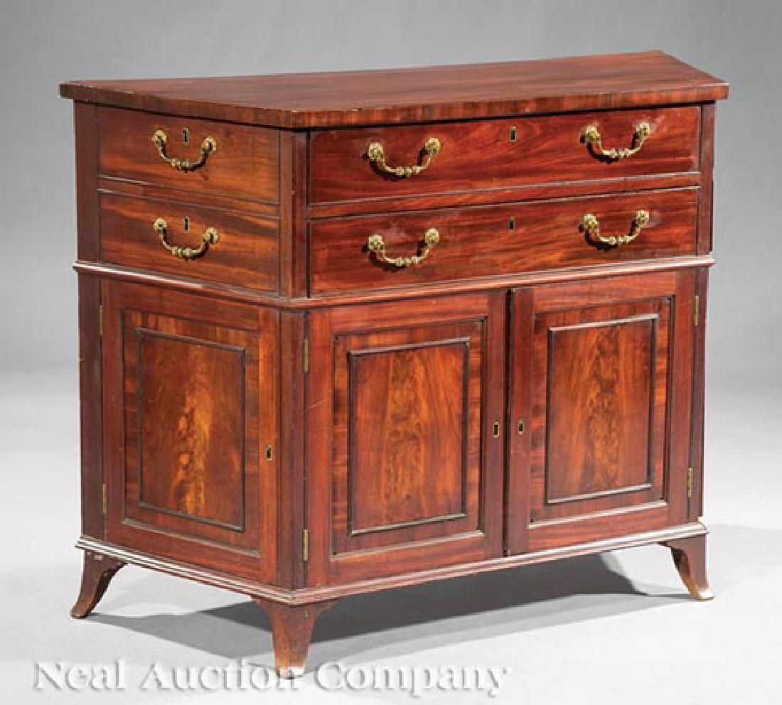 Pair of George III-Style Mahogany Commodes: Large Pair of George III-Style Mahogany Commodes, 19th c., trapezoidal top, conforming case with frieze drawers and paneled doors, flared feet, h. 35 in., w. 47 in., d. 18 in