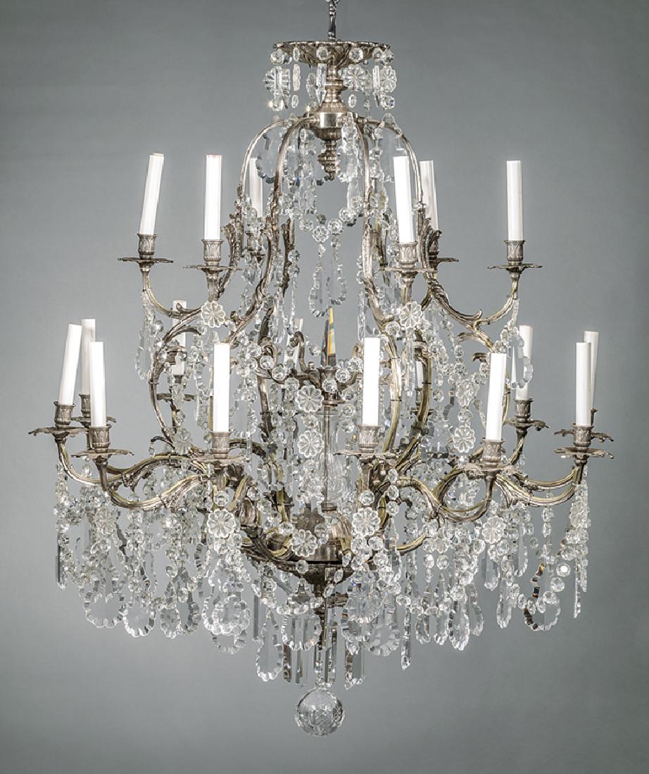 Italian Silvered Bronze, Cut-Crystal Chandelier: Italian Silvered Bronze and Cut-Crystal Eighteen-Light Chandelier, 20th c., scrolled arms, hung with spear prisms, pendeloques and rosettes, electrified, h. 53 in., dia. 44 in. Provenance: Bremermann
