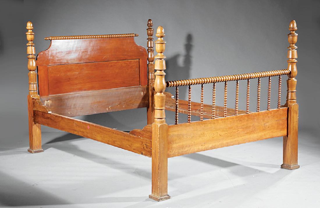 American Carved Walnut "Spool" Bed: American Carved Walnut "Spool" Bed, 19th c., shaped headboard, low spindled foot board, turned finialed posts, later rails, h. 51 1/4 in., l. 79 in., w. 57 1/4 in. Provenance: Found in Opelousas, LA