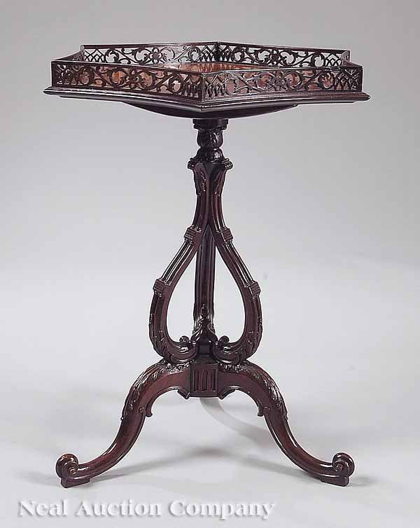 Georgian-Style Mahogany Tilt-Top Tea Table: A Georgian-Style Mahogany Tilt-Top Tea Table , c. 1900, in the manner of Thomas Chippendale, having a hexagonal top with incurvate reticulated gallery on tripartate support and leaf-carved cabriole le