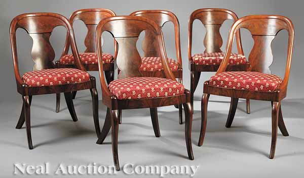 Ten Carved Mahogany Chaises en Gondole: A Set of Ten American Late Classical Carved Mahogany Chaises en Gondole , c. 1830-1840, the associated six and four chairs of nearly identical design featuring a molded arch crest rail, vasiform splat