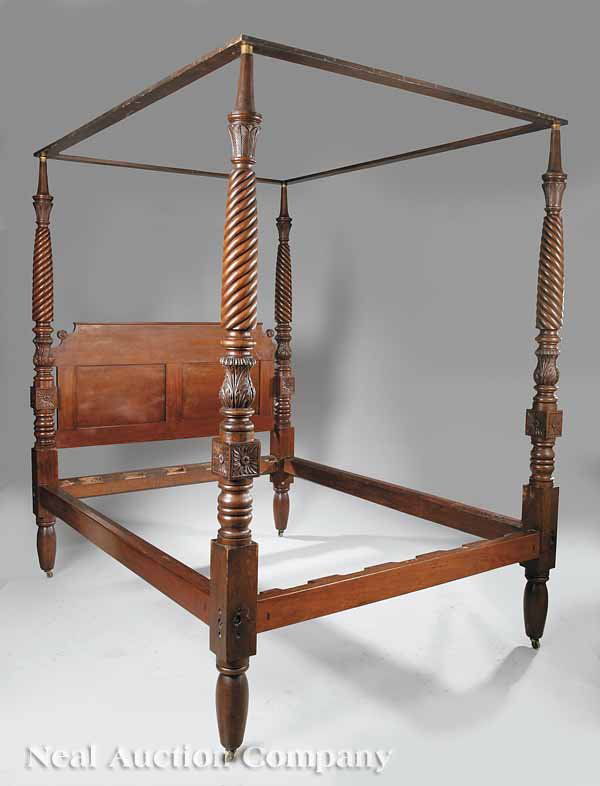Carved Mahogany and Walnut Four Poster Bed: An American Late Classical Carved Mahogany and Walnut Four Poster Bed , posts with "Egyptian" leaf-carved capitals, above cable turnings and leaf carved balusters, square blocks with rosettes, high pa