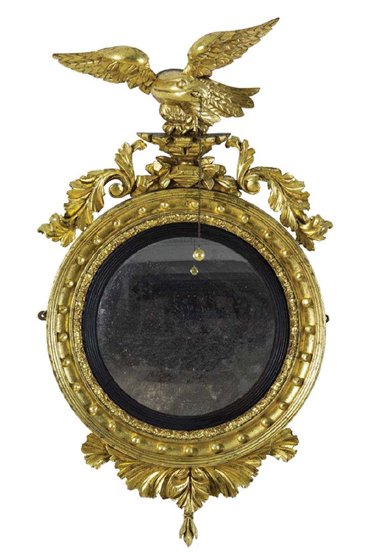 American or English Giltwood Bullseye Mirror: American or English Giltwood Bullseye Mirror, early 19th c., surmounted by a carved spreadwing eagle and acanthus molded surround decorated with spherules, ebonized rabbet, foliate pendant, h. 39 in.,
