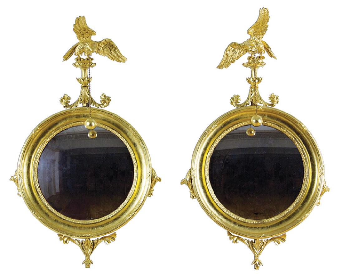 American or English Giltwood Bullseye Mirrors: Pair of American or English Giltwood Bullseye Mirrors, early 19th c., surmounted by a carved eagle, molded surround, foliate pendant, h. 42 1/2 in., w. 26 in. Provenance: Ginsburg & Levy Antiques, New
