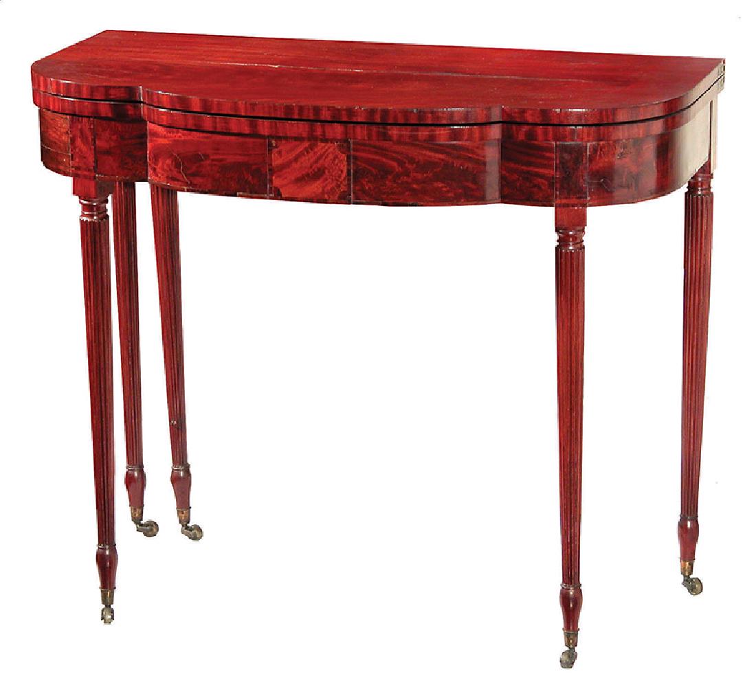 American Classical Inlaid Mahogany Games Table: American Classical Inlaid Mahogany Games Table, early 19th c., School of Duncan Phyfe, New York, shaped foldover top, conforming frieze, tapering reeded legs, casters, h. 31 in., w. 36 3/4 in., d. (cl