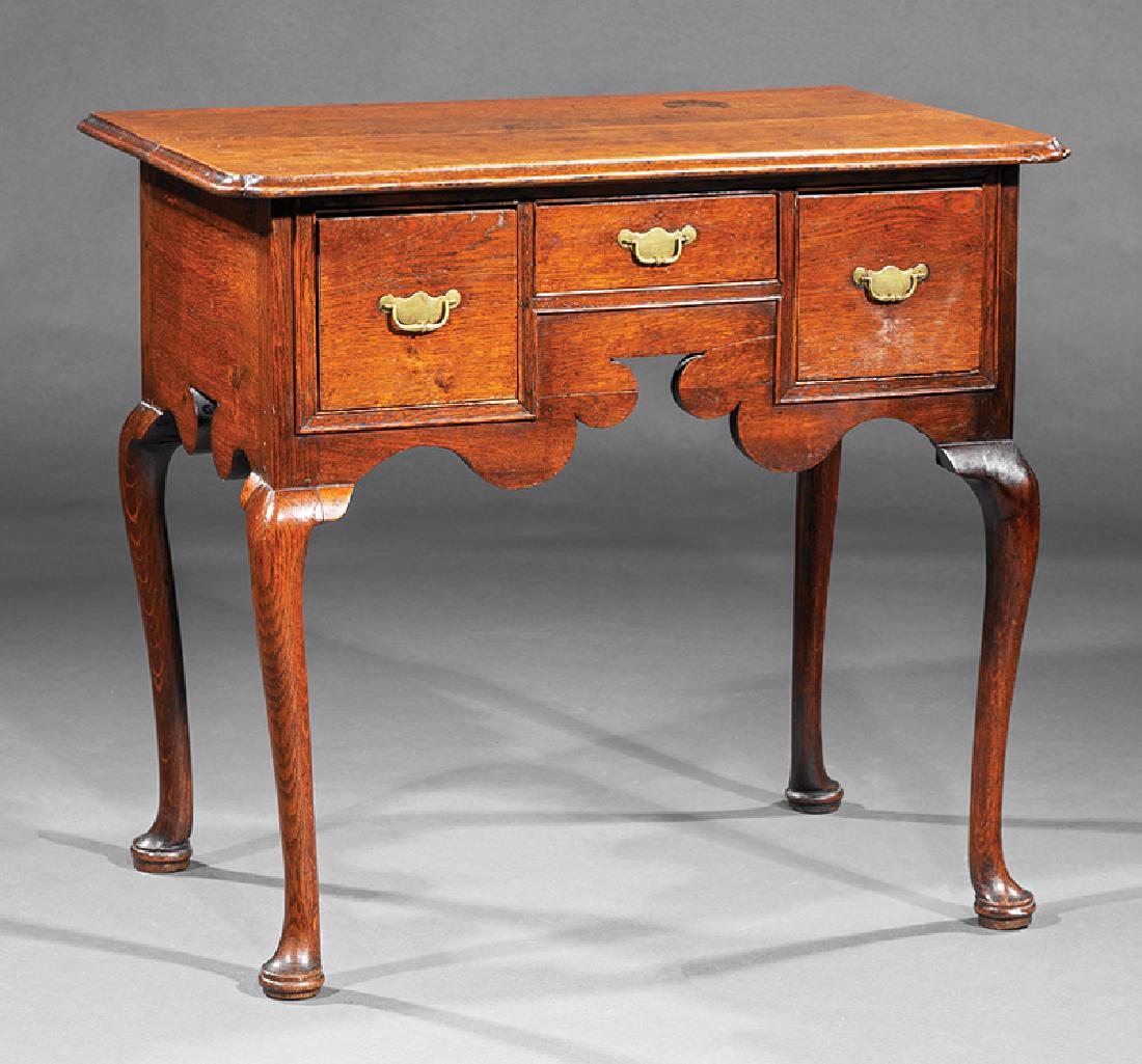 Queen Anne Oak Lowboy: Queen Anne Oak Lowboy, c. 1700, molded notched top, kneehole configuration of drawers, scalloped skirt, cabriole legs, pad feet, h. 29 1/2 in., w. 32 1/4 in., d. 21 1/4 in