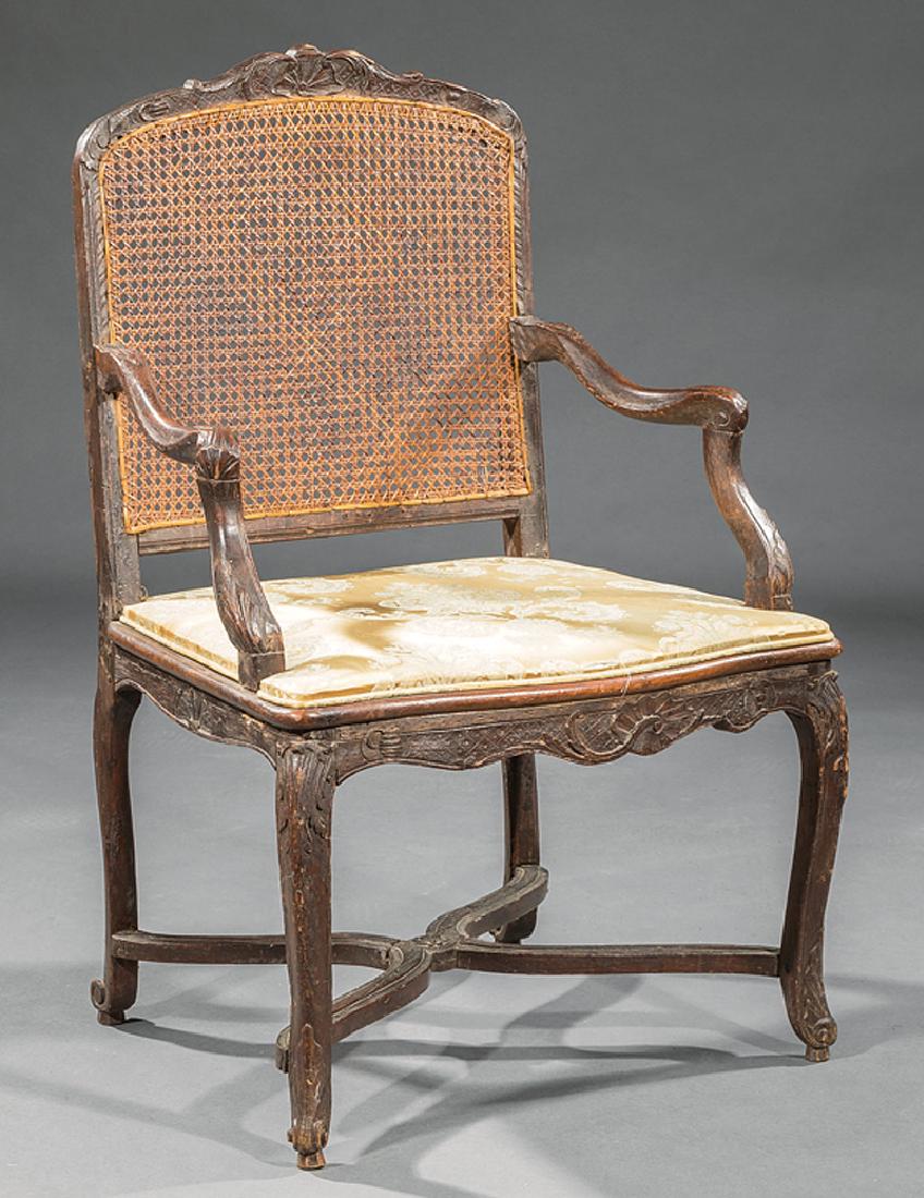 Regence Carved Beechwood Fauteuil: Regence Carved Beechwood Fauteuil, 18th c., serpentine shell-carved crest rail, foliate scrolled arms, caned back and seat, cabriole legs, shaped stretcher, h.38 1/2 in., w. 25 3/4 in., d. 20 in. Prov