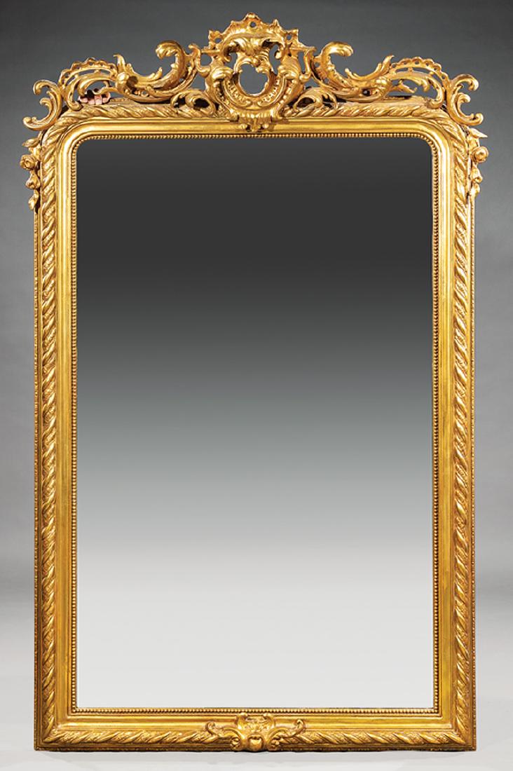 Pair of Continental Rococo-Style Giltwood Mirrors: Pair of Continental Rococo-Style Giltwood Mirrors, 20th c., cabochon and acanthus scrolled crest, ropework and beaded frame, conforming base, h. 83 in., w. 52 in. Provenance: Williamson-LeBlanc Collec