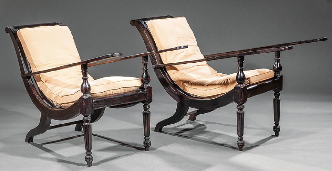 Pair of Anglo-Colonial-Style Planter's Chairs: Pair of Anglo-Colonial-Style Planter's Chairs, 20th c., slatted backs and seats, flat arms or foot rests, reeded, turned tapered legs, peg feet, h. 33 in., l. 53 in., w. 24 1/2 in.,