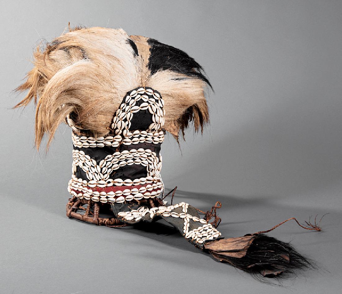 African "Poro Society" Headdress: African Hair, Hide, Cowrie Shell and Wicker "Poro Society" Headdress, Kran, Liberia, interior filled/lined with feathers, h. (approx.) 16 3/4 in., w. (approx.) 16 in., d. (approx.) 9 in.; tail l. 19 i