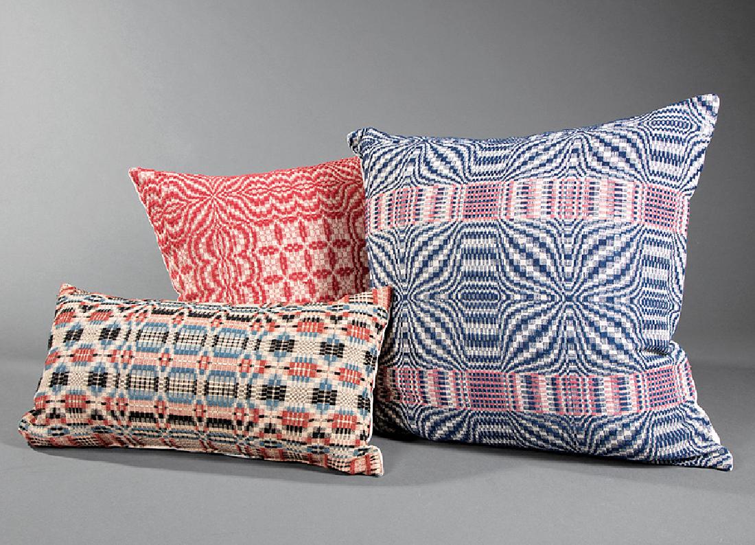 Three American "Coverlet" Pillows: Three American "Coverlet" Pillows, 20th c., made from antique coverlets, 19 in. x 8 in. x 5 in.; 18 in. x 18 in. x 8 in., and 14 in. x 14 in. x 6 in. Provenance: Property of the Mobile Museum of Art, 