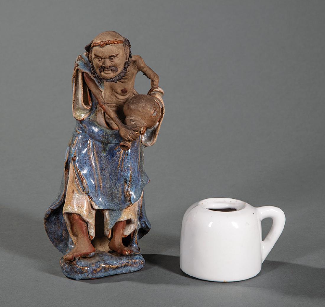 Chinese Shiwan Pottery "Mud Man" Figure Li Tiequai: Chinese Shiwan Glazed and Molded Pottery "Mud Man" Figure of Li Tiequai, modeled holding a wine barrel wearing long robes open at the front revealing a bare chest, h. 8 1/4 in.; together with a white