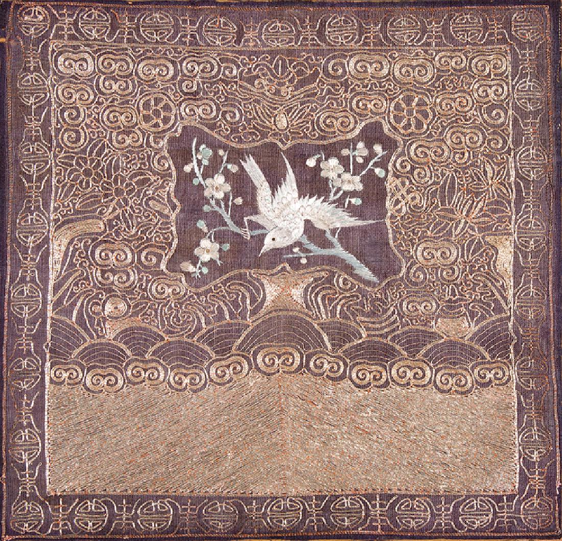 Chinese Embroidered Panel: Chinese Embroidered Panel, late 19th/early 20th c., worked in satin stitch with a central bird-on-branch cartouche above waves and mountains in couched metallic threads, border with longevity symbols/