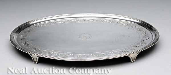 George III Crested Sterling Silver Oval Salver: A George III Crested Sterling Silver Oval Salver , Robert Salmon (mark entered 1773), London, 1801-02, the flat surface with bright-cut engraved borders, reeded edge and raised on four paneled feet, h