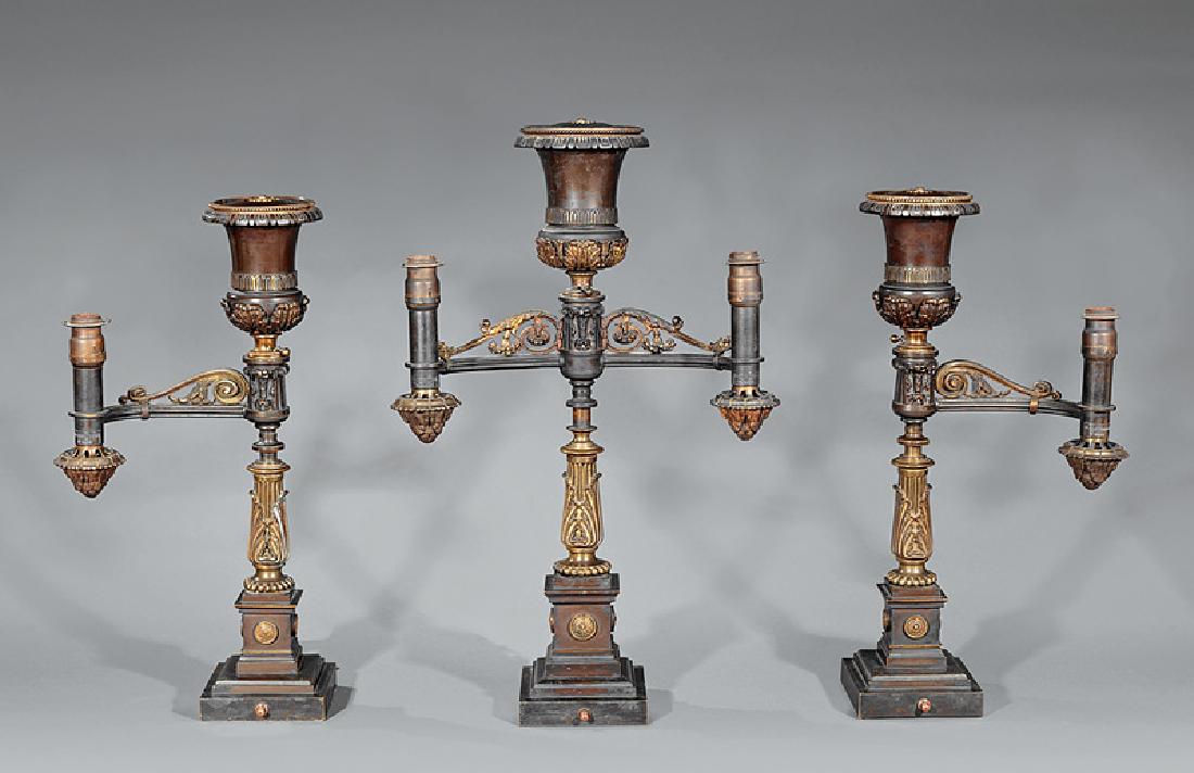 B. Gardiner Argand Lamp Garniture: American Gilt and Patinated Bronze Three-Piece Argand Lamp Garniture, 19th c., burners marked "B. GARDINER/ N. YORK", foliate and scroll design, plinth base with rosettes, now electrified, central lam