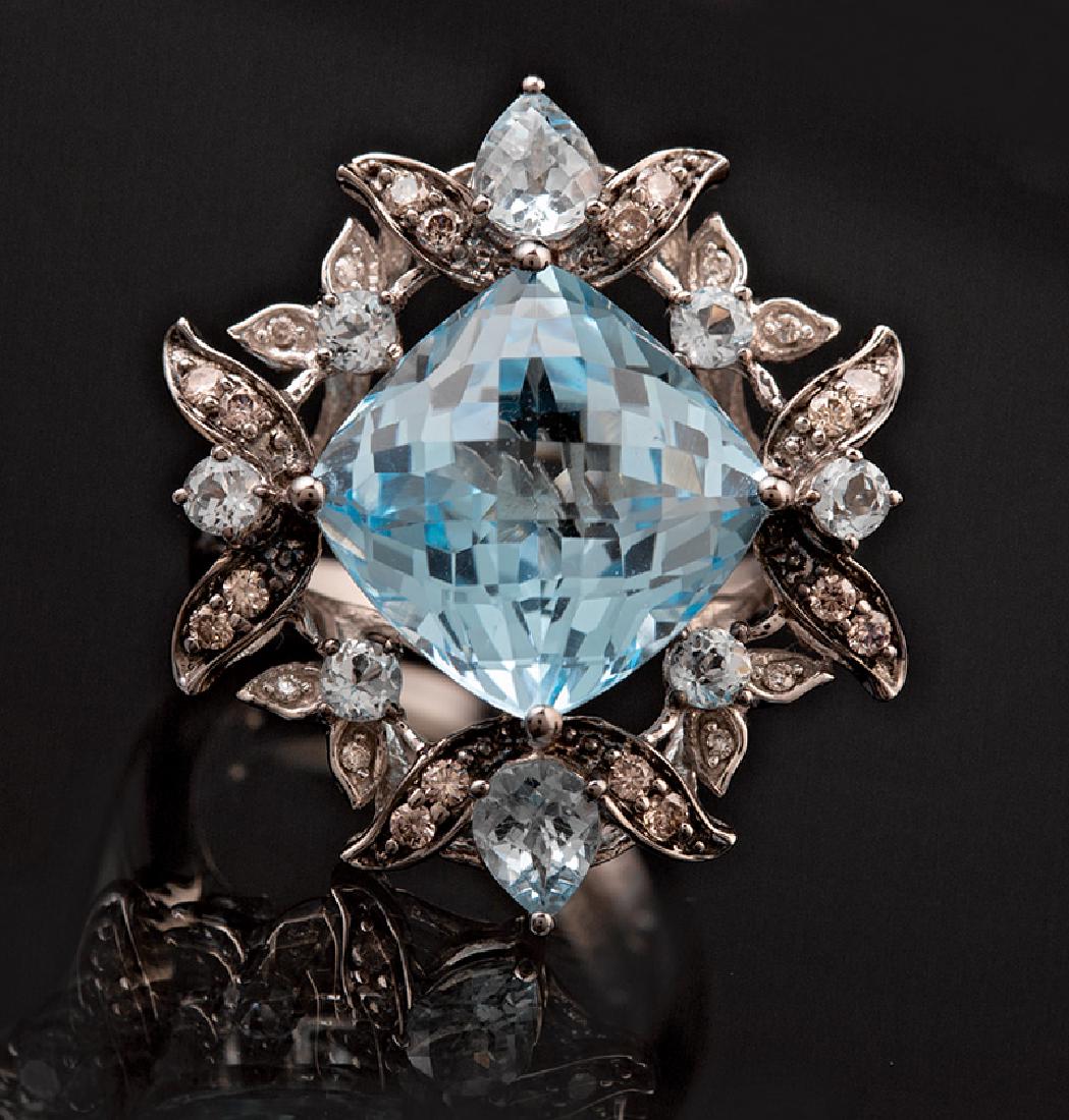 Levian Gold, Blue Topaz, Diamond Ring: Levian 14 kt. White Gold, Blue Topaz, Chocolate and Vanilla Diamond Ring, set with a cushion-shape checkerboard faceted blue topaz, approx. 9 cts., 2 small pear-shaped and 6 round faceted blue topazes