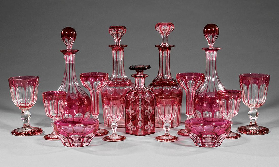French Ruby Cut-to-Clear Crystal Stemware: Set of Antique French Ruby Cut-to-Clear Crystal Stemware, probably Val St. Lambert, incl. 2 pairs of decanters, h. 11 3/4 in. and 12 in.; decanter, h. 7 1/2 in.; 17 water goblets, h. 6 3/8 in.; 16 hol