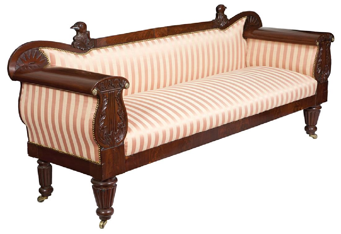 William IV Carved Mahogany Sofa: William IV Carved Mahogany Sofa, c. 1830, shaped crest rail surmounted by eagle heads, lyre-form uprights, turned, tapered and reeded legs, casters, h. 35 1/2 in., l. 84 in., d. 24 in. Provenance: The