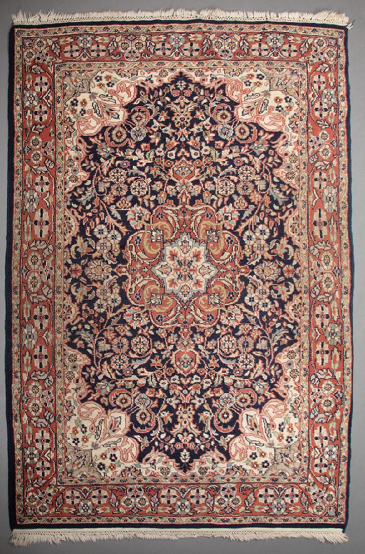 Small Kerman Carpet: Small Kerman Carpet, blue ground with central medallion encircled by floral scrolls and flower heads, red border with flower heads and scrollwork, 3 ft. 11 1/2 in. x 6 ft IMPORTANT: All purchases must