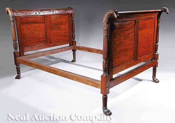 American Classical Carved Mahogany Bed: An American Classical Carved Mahogany Bed , 19th c., New York, after Duncan Phyfe or Charles-Honoré Lannuier, the crest rails swagged, beribboned and tasseled, paneled below, the posts terminating in