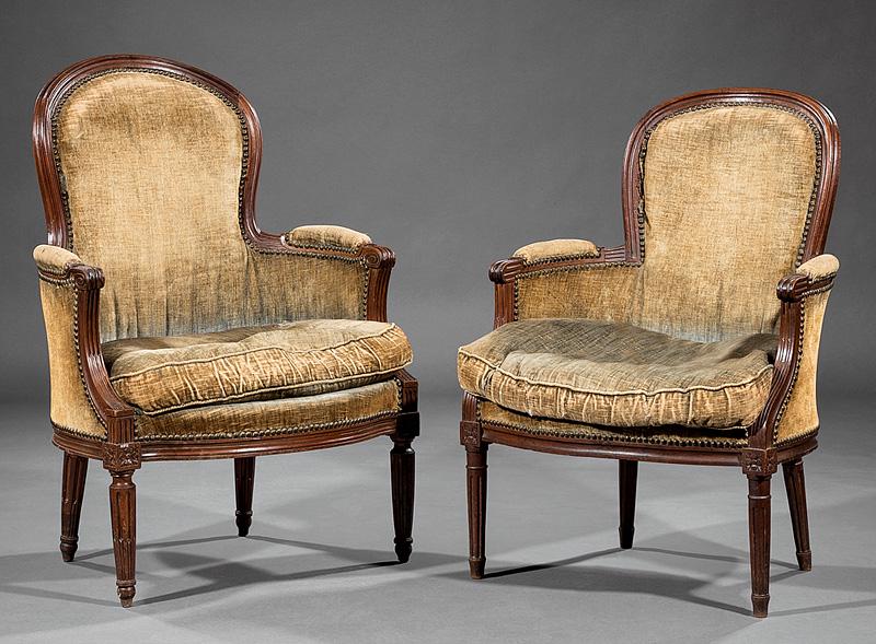 Louis XVI-Style Carved Mahogany Bergeres: Two Antique Louis XVI-Style Carved Mahogany Bergeres , each with molded crest rail, scrolled arms, stop-fluted tapered legs, taller h. 39 3/4 in., w. 27 1/4 in., d. 25 in., shorter h. 36 5/8 in., w. 2