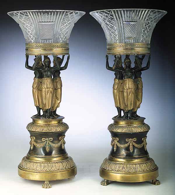 A Pair of Austrian Belle Epoque Patina: A Pair of Austrian Belle Epoque Patinated and Gilt Metal Epergnes , with a near pair of cut crystal bowls on figural supports, swagged socle and paw feet, height 17 1/2 in., diameter 8 in NO RETURNS A
