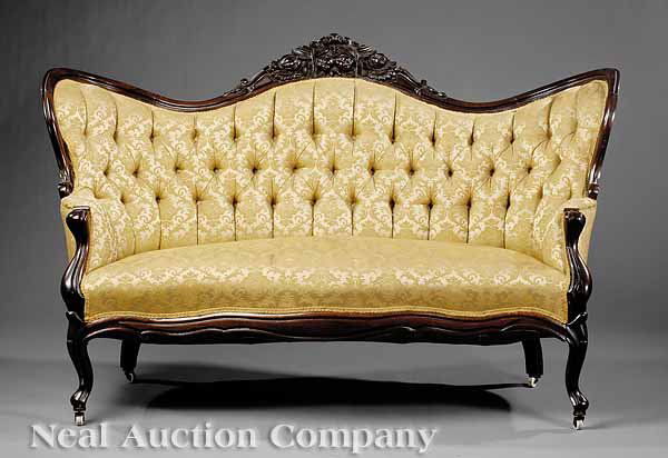 Pair of American Rococo Carved Rosewood Settees: A Pair of American Rococo Carved Rosewood Settees , mid-19th c., scalloped fruit and nut carved crest, low shaped arms, serpentine seat rail, cabriole legs, height 41 in., width 65 in., depth 20 in.;
