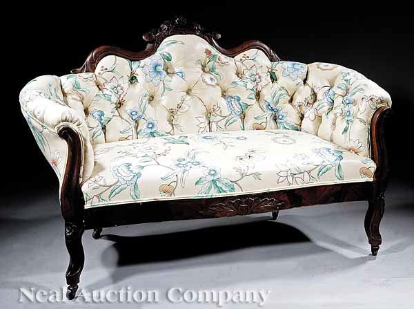 Pair of American Rococo Mahogany Settees: A Pair of American Rococo Mahogany Settees , c. 1840-1850, of diminutive form, each undulating backrest with floral crest above scrolled arms, the serpentine outlined seat centered by flowers and leav