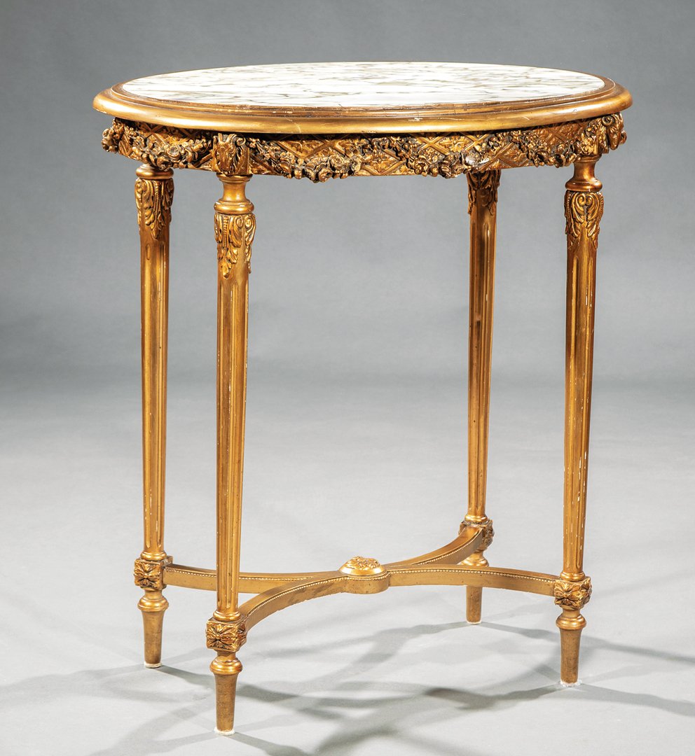 Louis XVI-Style Carved Giltwood Gueridon: Louis XVI-Style Carved Giltwood Gueridon, inset marble top, floral swag frieze, tapered fluted legs, incurvate stretcher, toupie feet, h. 30 in., w. 27 1/2 in., d. 20 1/2 in. IMPORTANT: All purchases 
