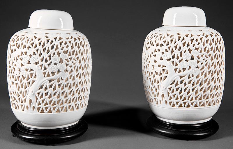 Chinese White Glazed Pottery Covered Lanterns: Pair of Chinese White Glazed Pottery Covered Lanterns , 20th c., reticulated bodies carved with ruyi heads, bamboo leaves, and flowering prunus branches, pierced covers and bases, h. 10 1/2 in., wood