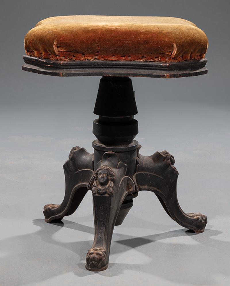American Cast Iron Piano Stool: American Cast Iron Piano Stool , mid-19th c., shaped swivel top, baluster standard, bust and lion mask legs, h. 18 in., l. 14 in., d. 14 in. Condition: Structurally sound. Oxidation, patination to met