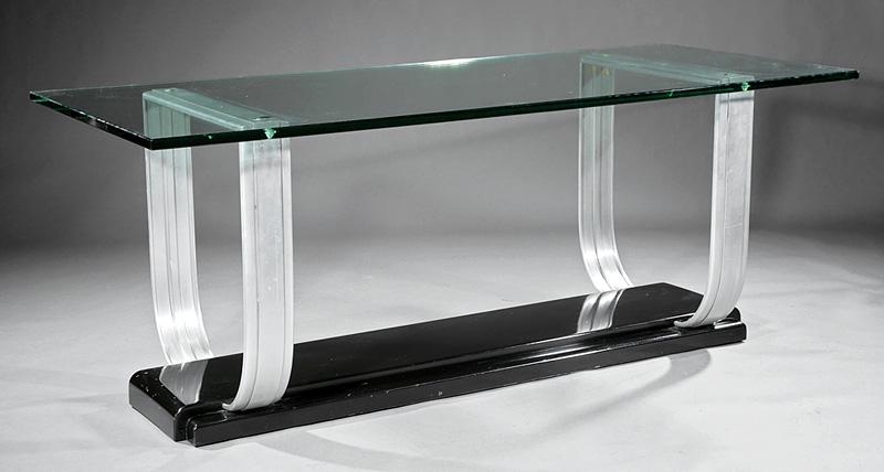 Art Moderne Chrome and Glass Console Table: Art Moderne Chrome and Glass Console Table , 20th c., glass top on burnished yoke supports connected to a stepped plinth base , h. 31 in., w. 79 in., d. 33 3/4 in. Provenance: Collection of Nan Wier, 