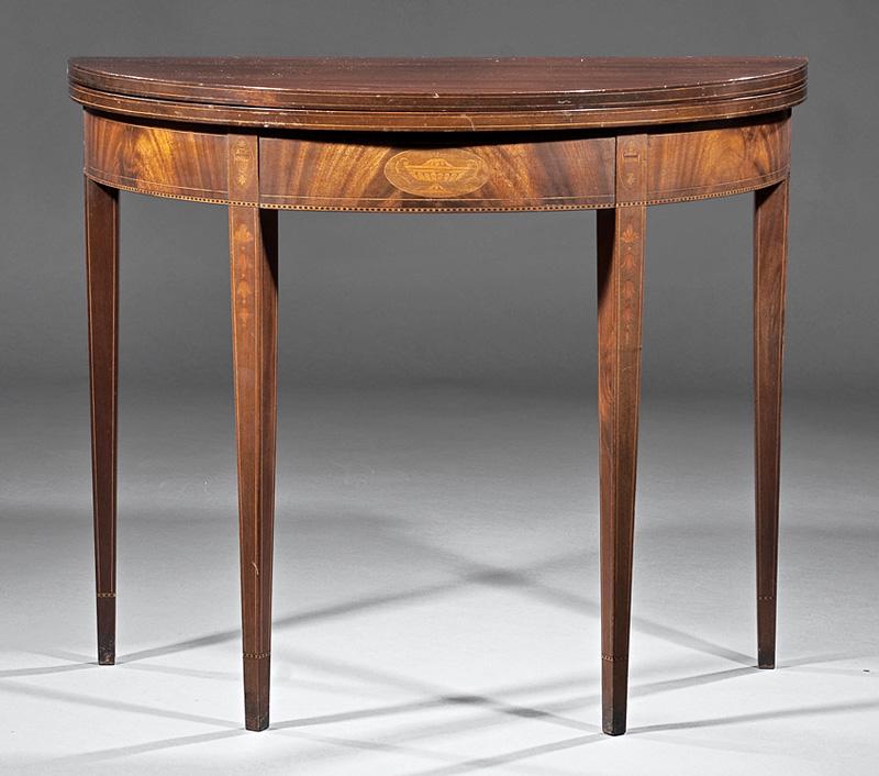 English Inlaid Mahogany Games Table: English Inlaid Mahogany Games Table , demilune fold-over top, conforming frieze, square tapered legs with bellflowers, h. 30 in., w. 36 in., d. 18 in IMPORTANT: All purchases must be removed from our 